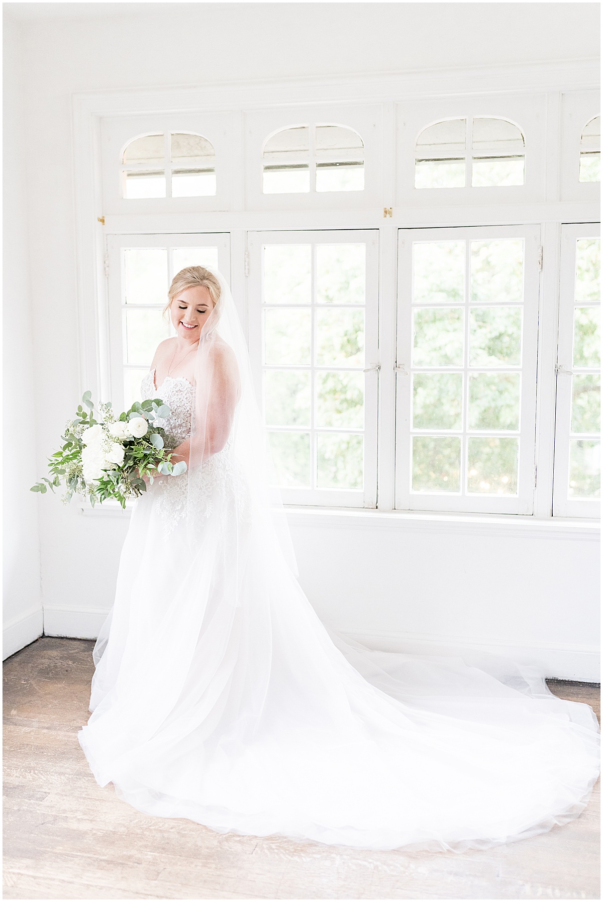 Bride showcasing dress with train for Fowler House Mansion wedding