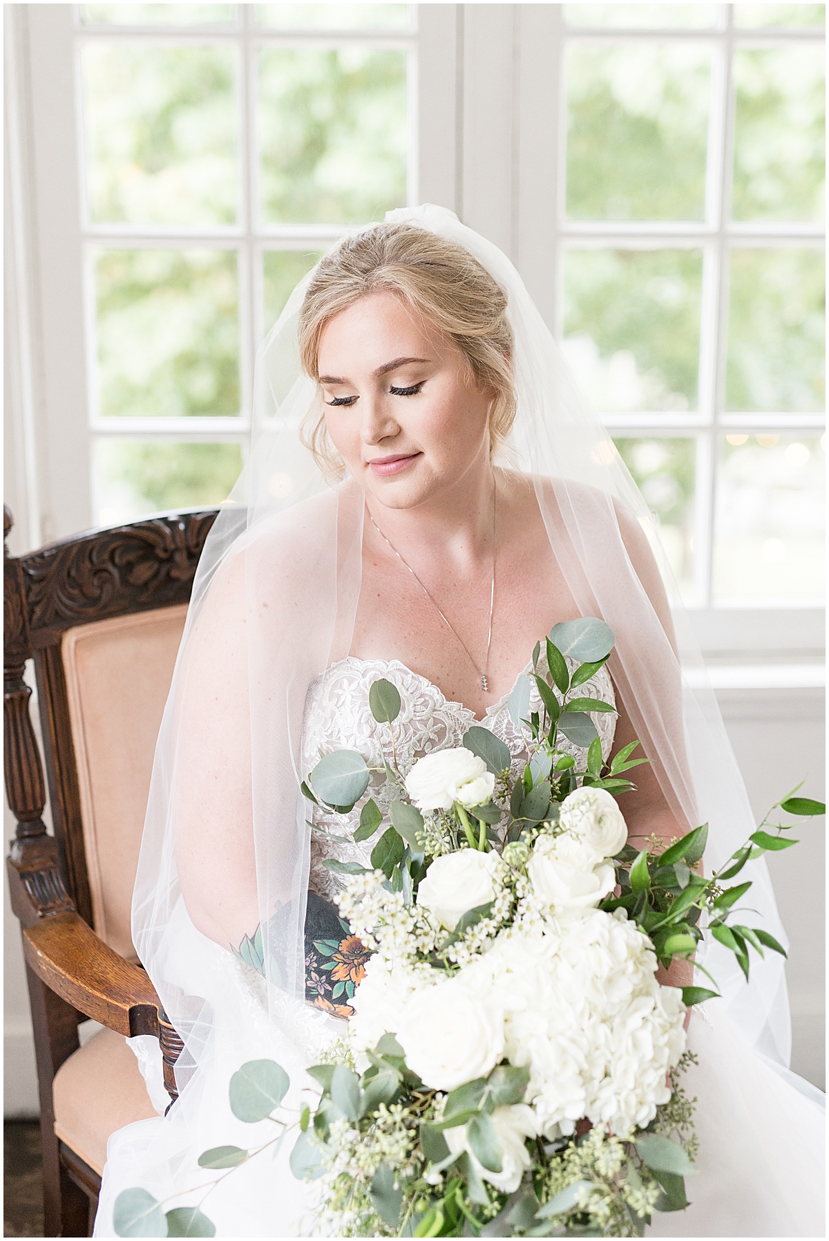 Bride before Fowler House Mansion wedding with white flowers