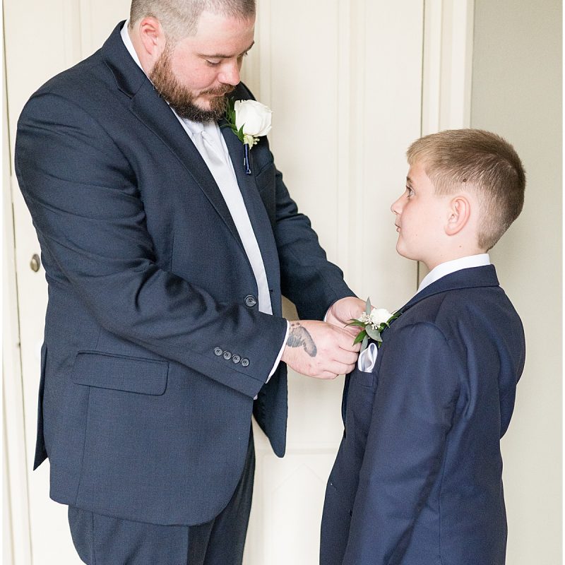 Groom helping son get ready for wedding at Fowler House Mansion