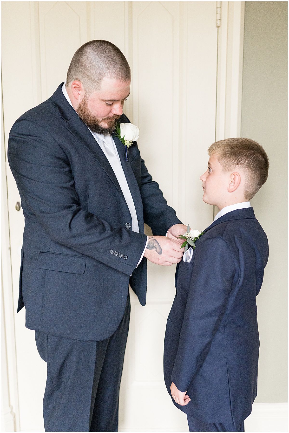 Groom helping son get ready for wedding at Fowler House Mansion