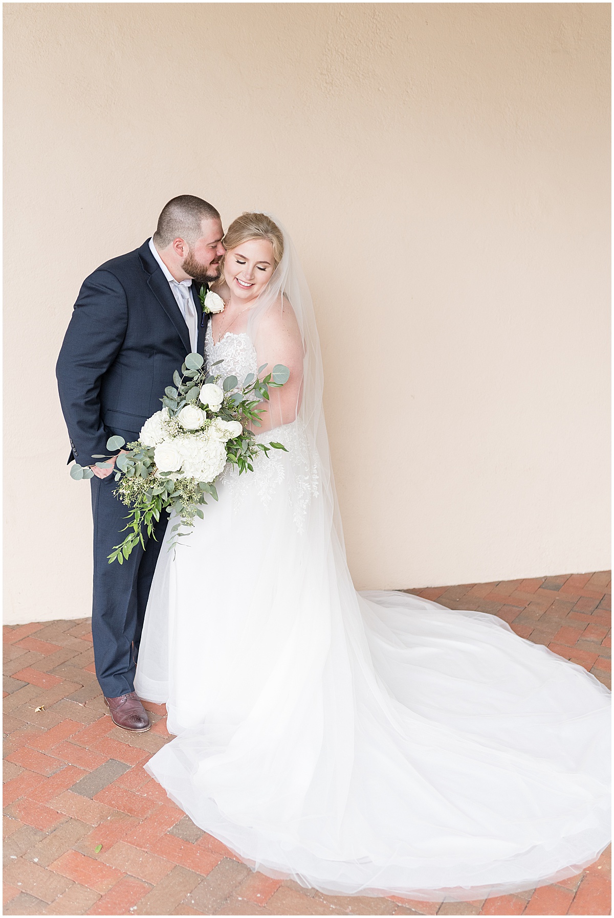 Bride and groom embrace during wedding photos at Fowler House Mansion