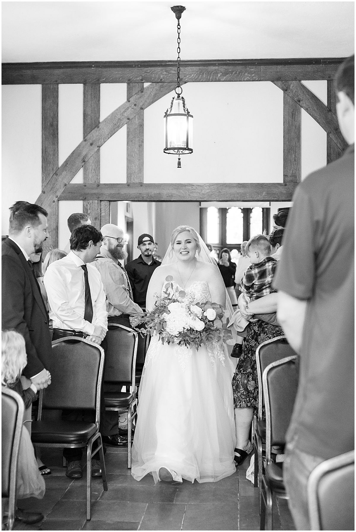 Bride walking down the aisle during Fowler House Mansion wedding ceremony