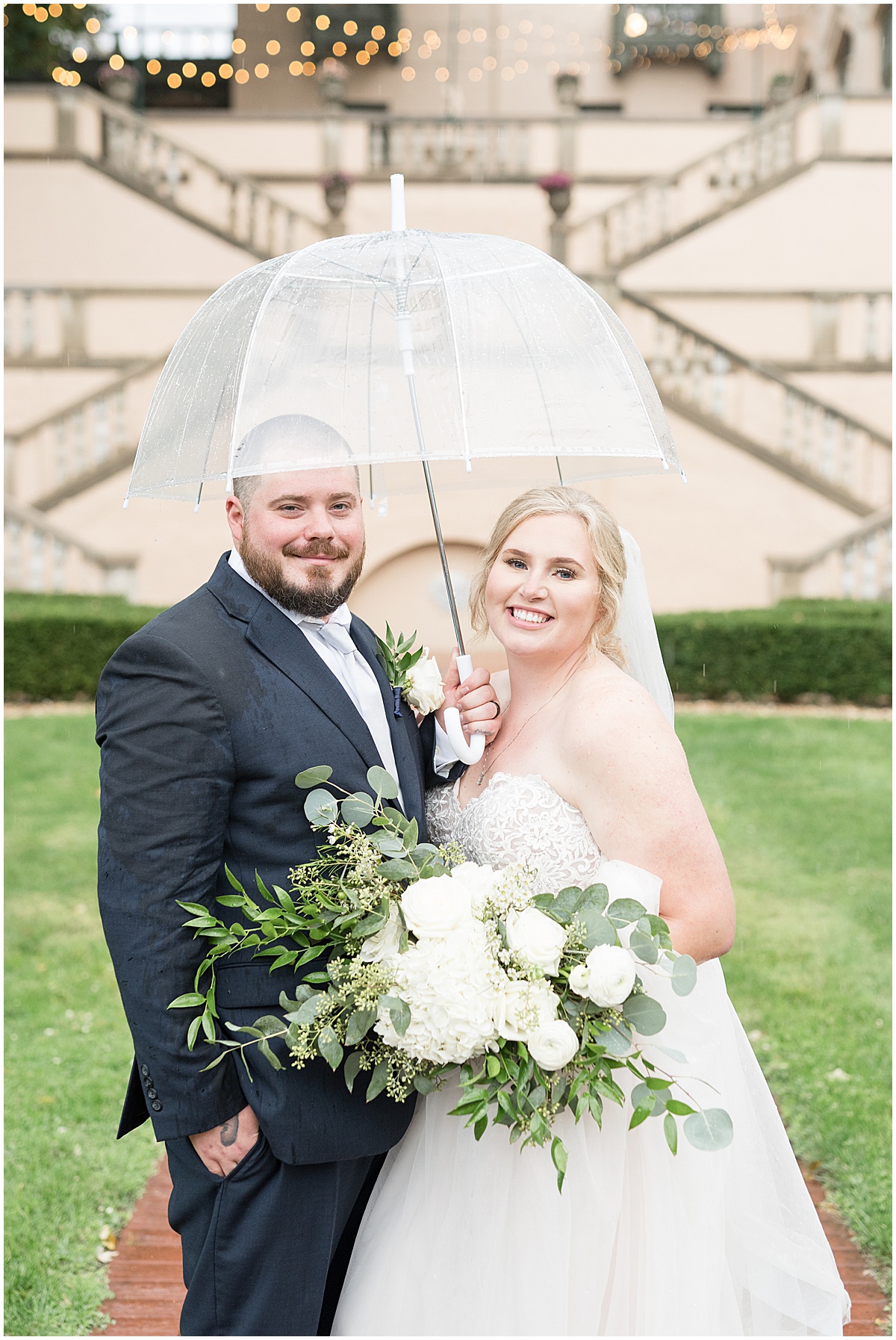 Bride and groom under umbrella at Fowler House Mansion wedding