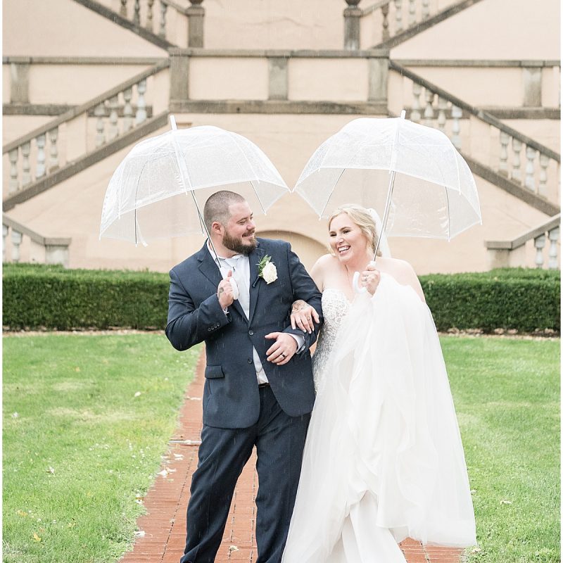 Bride and groom dancing in the rain outside Fowler House Mansion wedding
