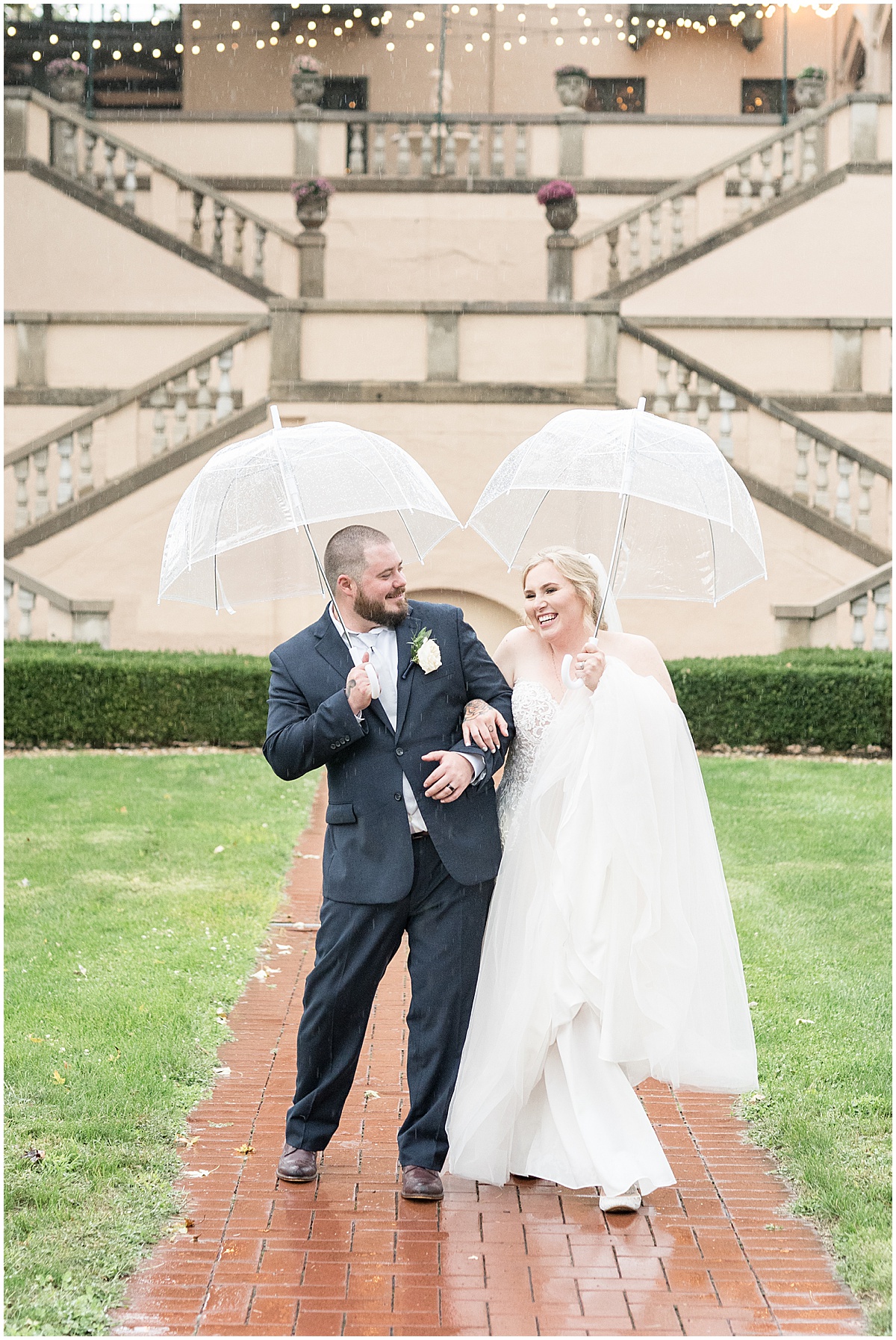 Bride and groom dancing in the rain outside Fowler House Mansion wedding
