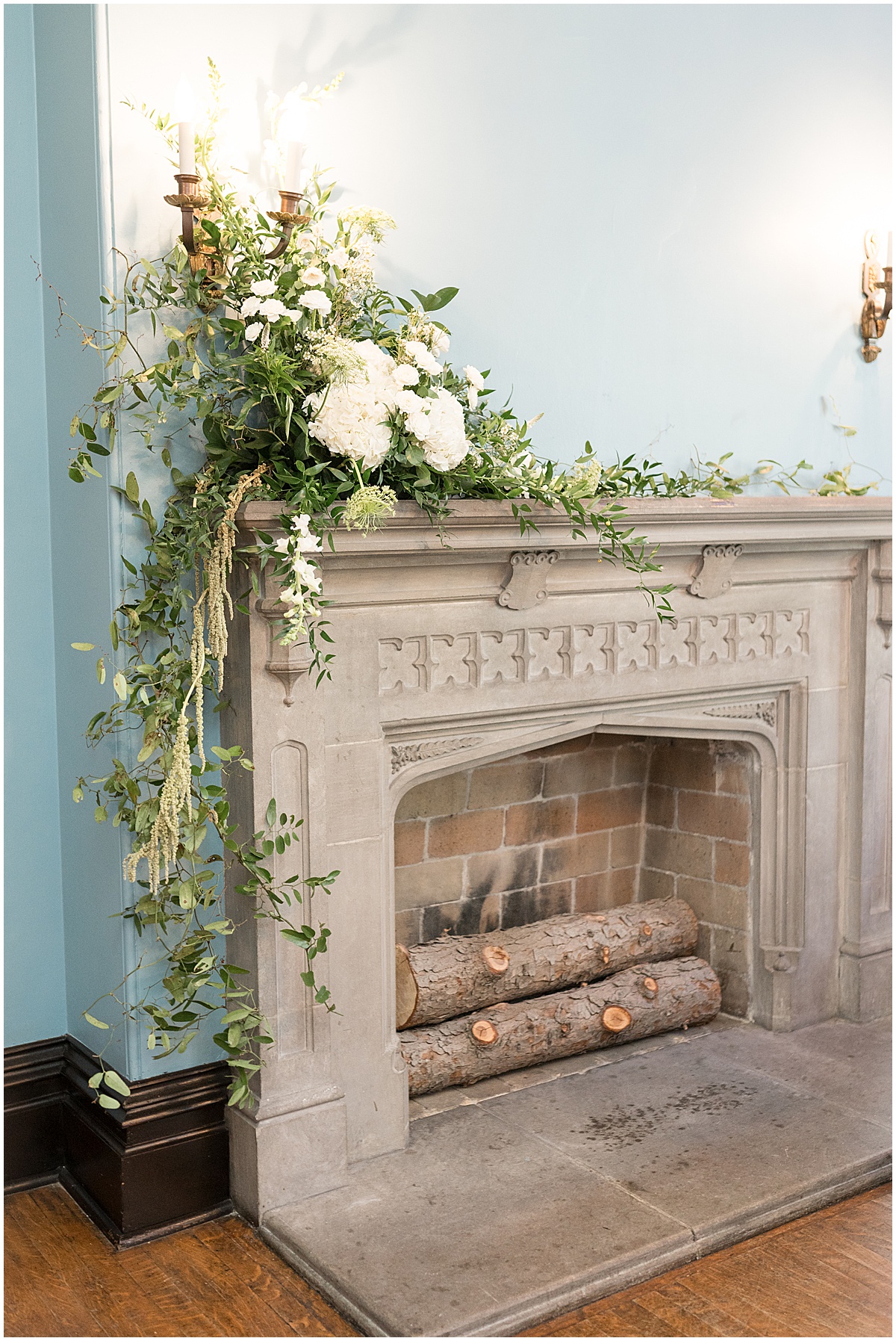 Fireplace inside Fowler House Mansion covered in wedding flowers