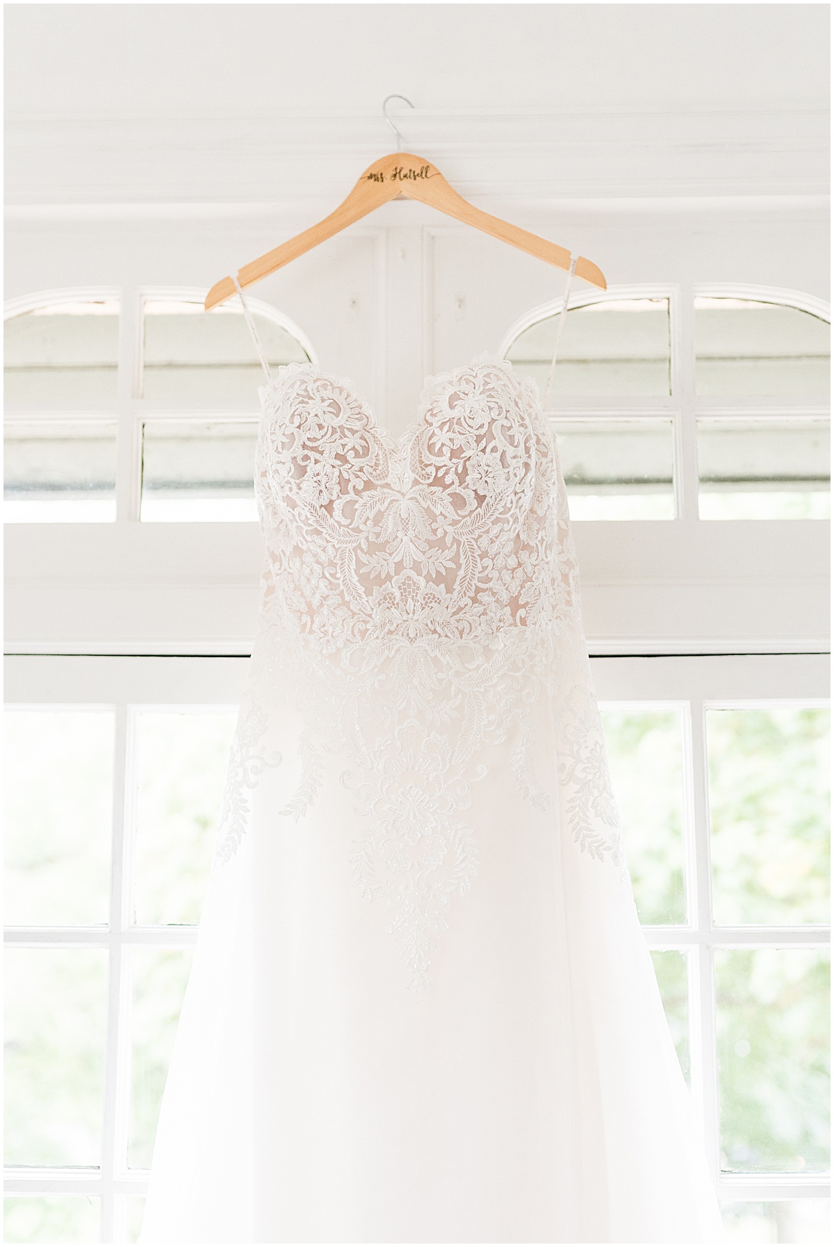 Wedding dress hanging in window before wedding at Fowler House Mansion