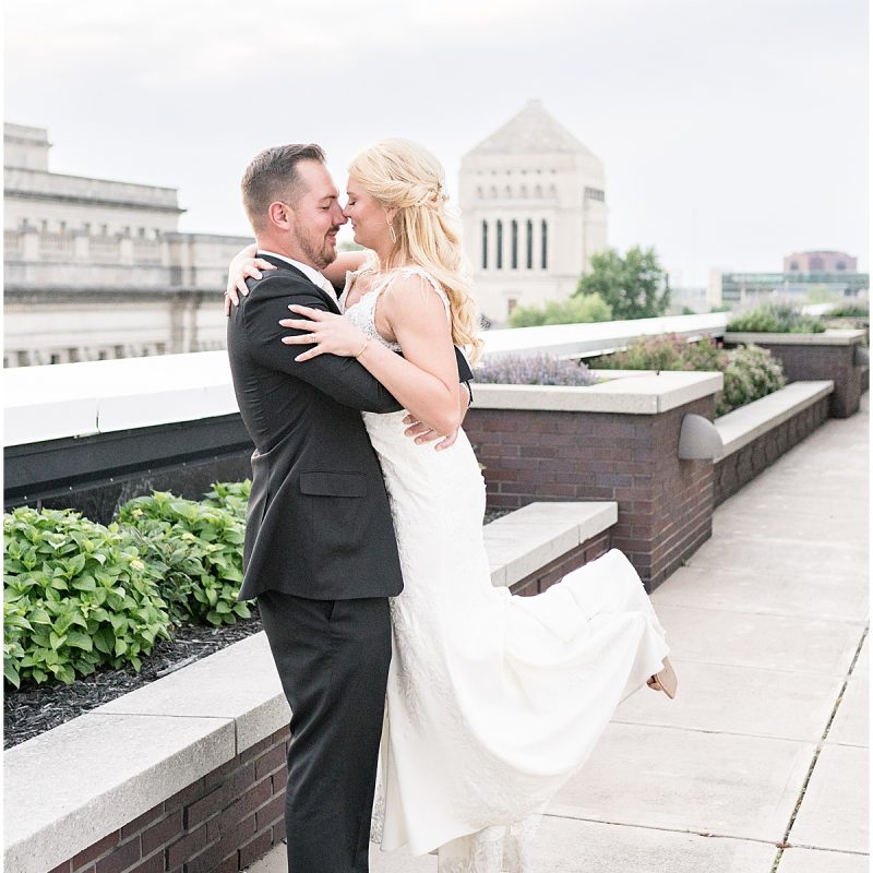 Groom lifts bride after JPS Events Wedding Reception in Downtown Indianapolis