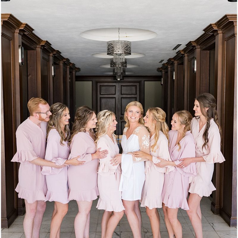 Bride laughing with bridesmaids in matching robes before JPS Events Wedding in Downtown Indianapolis