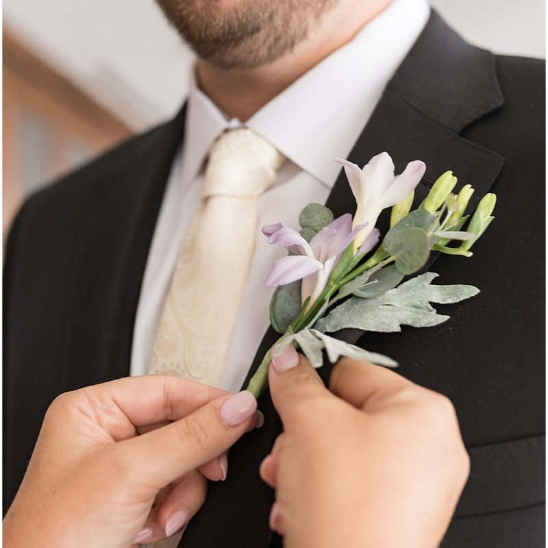 Groom gets on boutonnière at JPS Events Wedding in Downtown Indianapolis