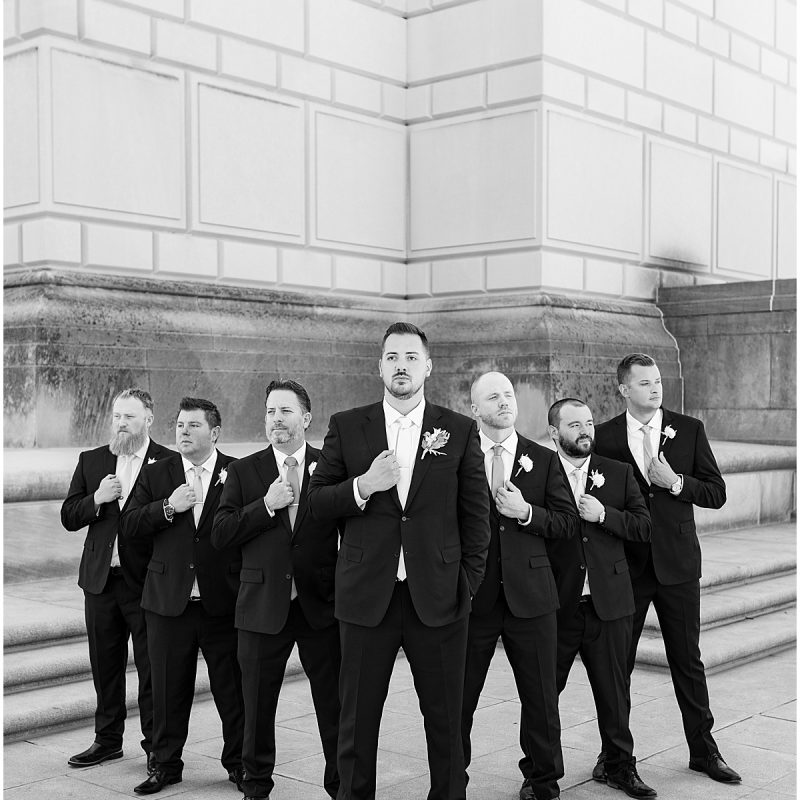 Groom with groomsmen with serious pose at at The Indiana World War Memorial in Downtown Indianapolis
