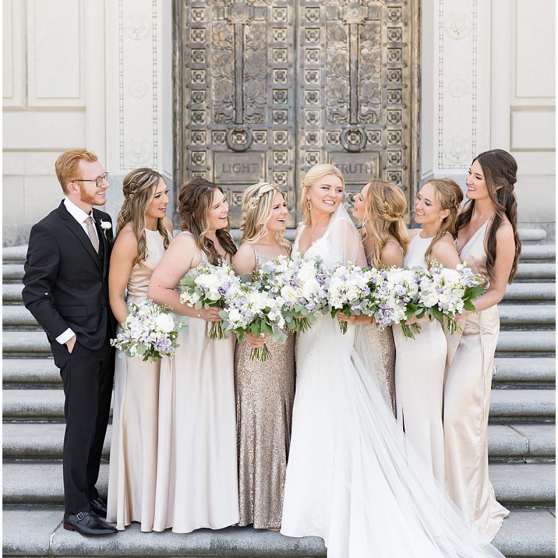Bridesmaids admire bride on steps of at The Indiana World War Memorial in Downtown Indianapolis