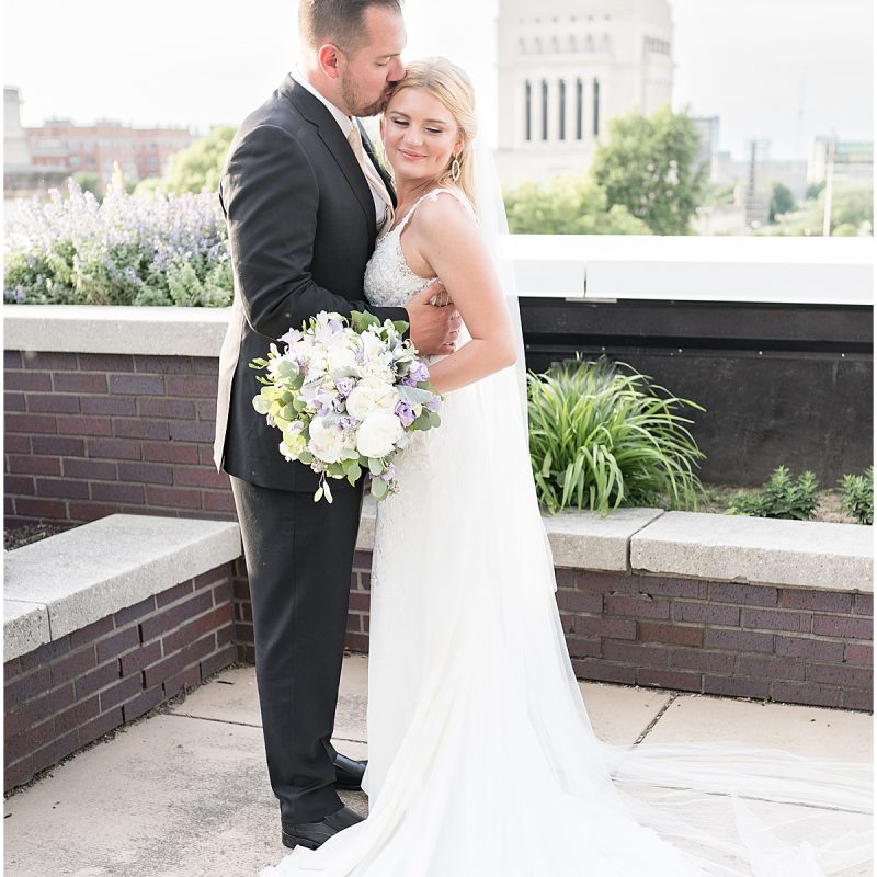 Groom kisses bride on rooftop of JPS Events Wedding in Downtown Indianapolis