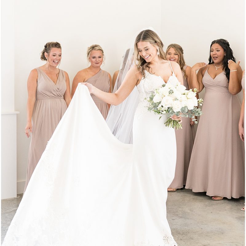 Bride twirling wedding dress for bridesmaids at New Journey Farms
