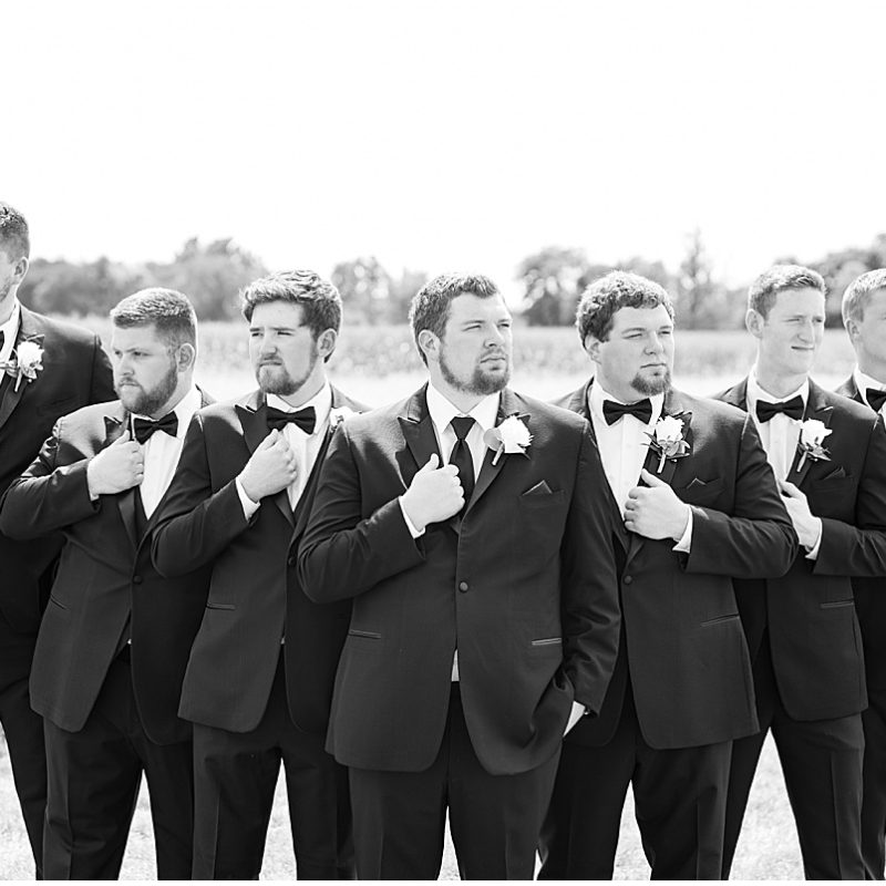 Groom and groomsmen with serious faces at New Journey Farms