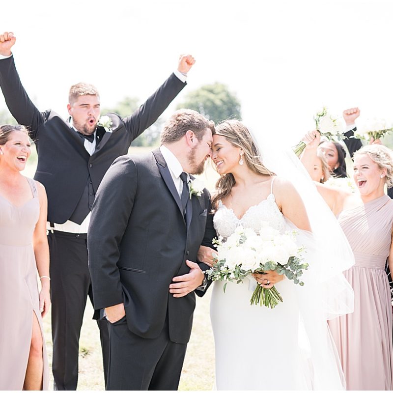 Bridal party cheers for couple at New Journey Farms