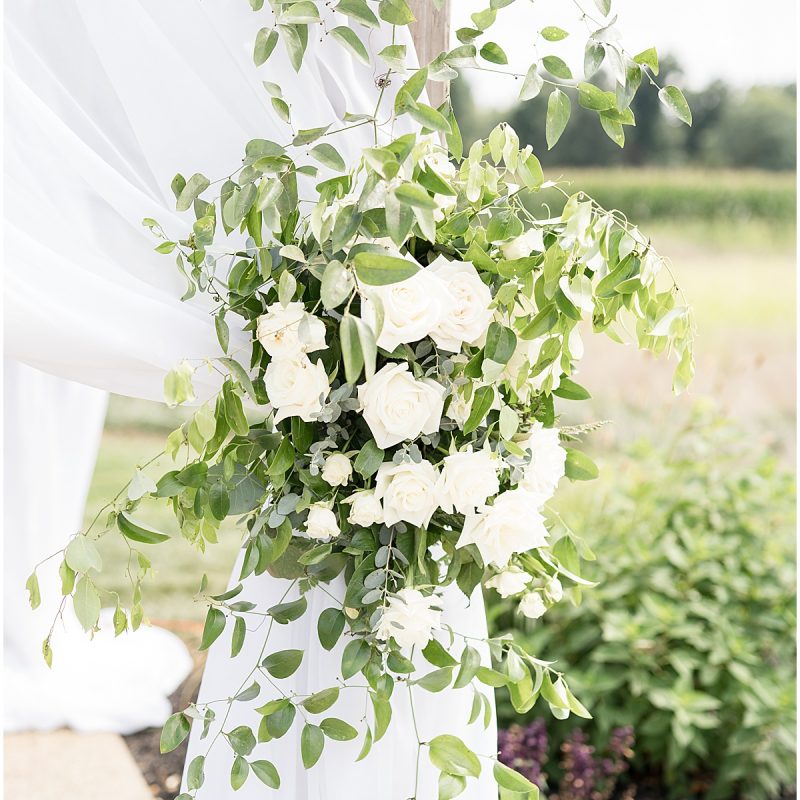 Floral detail on wedding arch at New Journey Farms