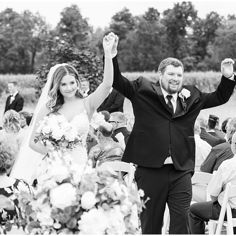 Bride and groom celebrate during exit of New Journey Farms Wedding
