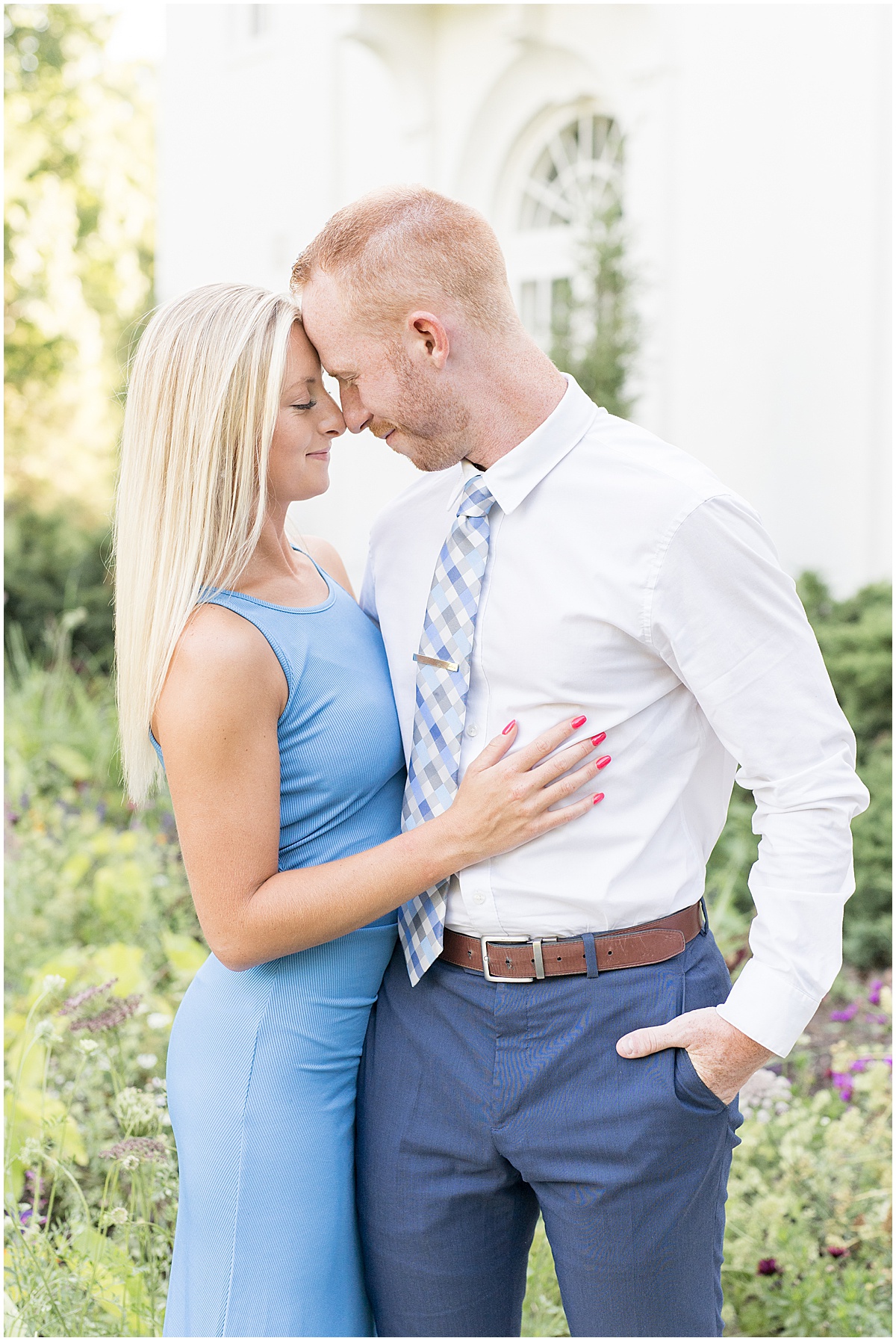 Couple enjoy moment together during summer engagement at Newfields in front of the Lily House
