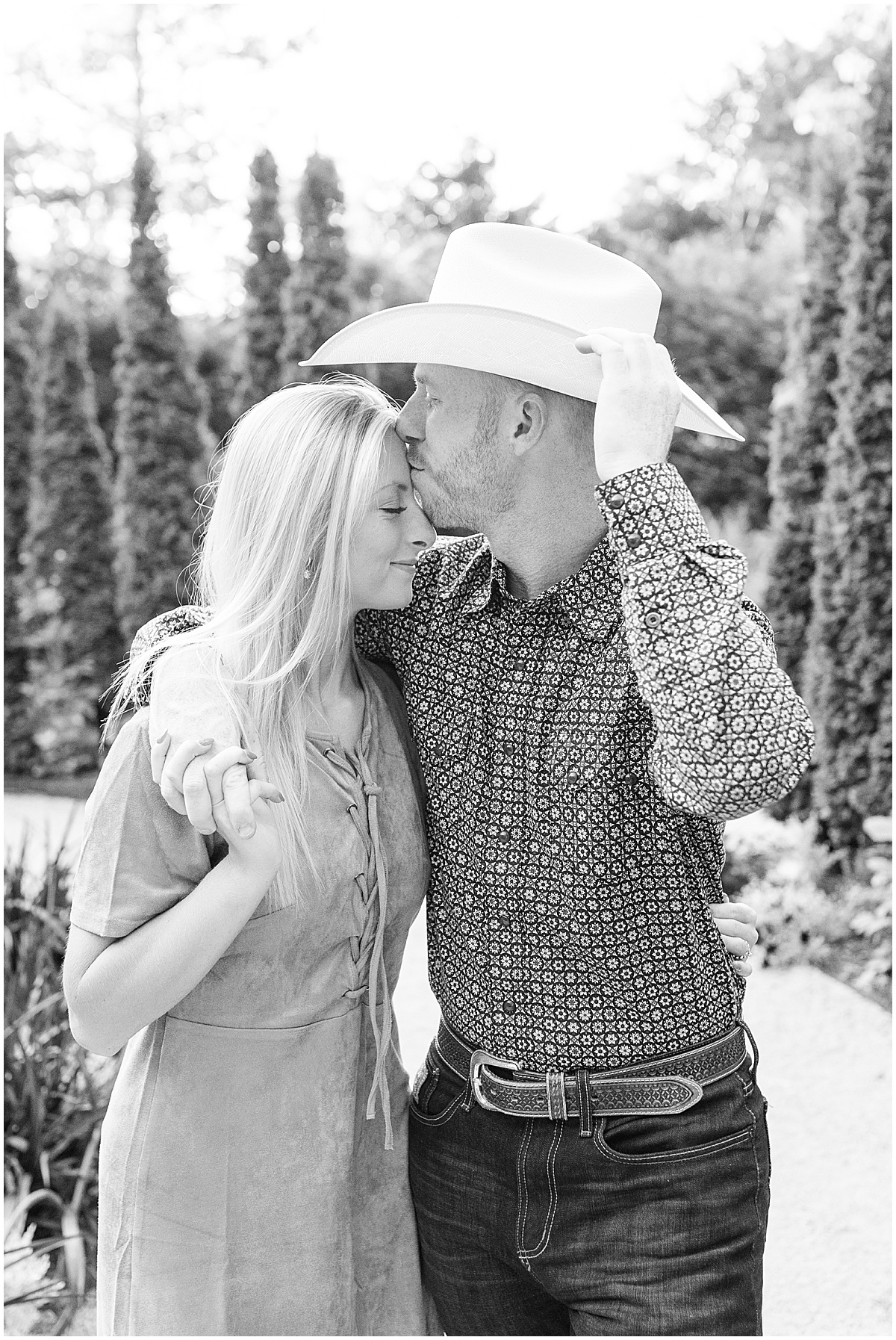 Couple kissing during western-inspired engagement photos at Newfields