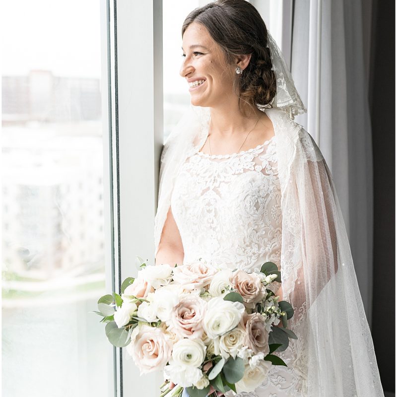 Bride looking out window before wedding at Indianapolis Hebrew Congregation
