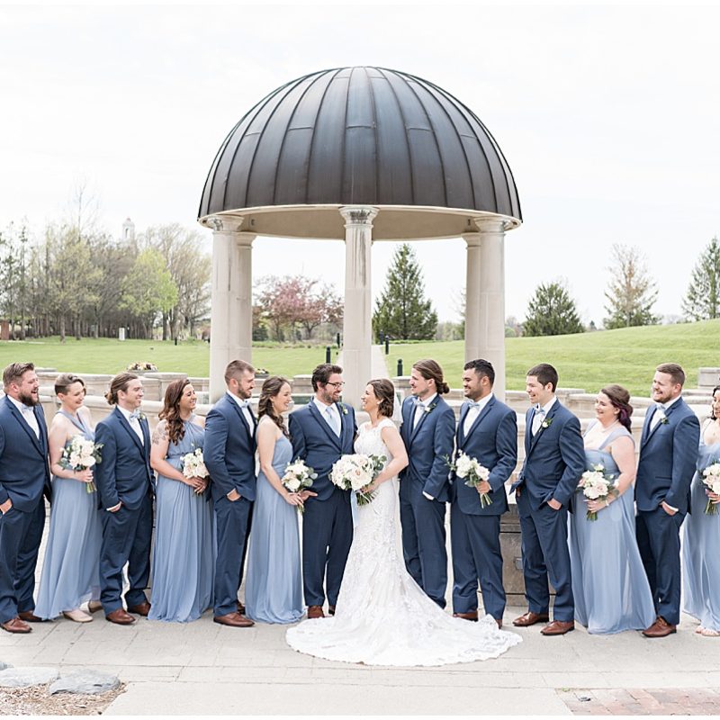 Bridal party laugh together during wedding photos at Coxhall Gardens