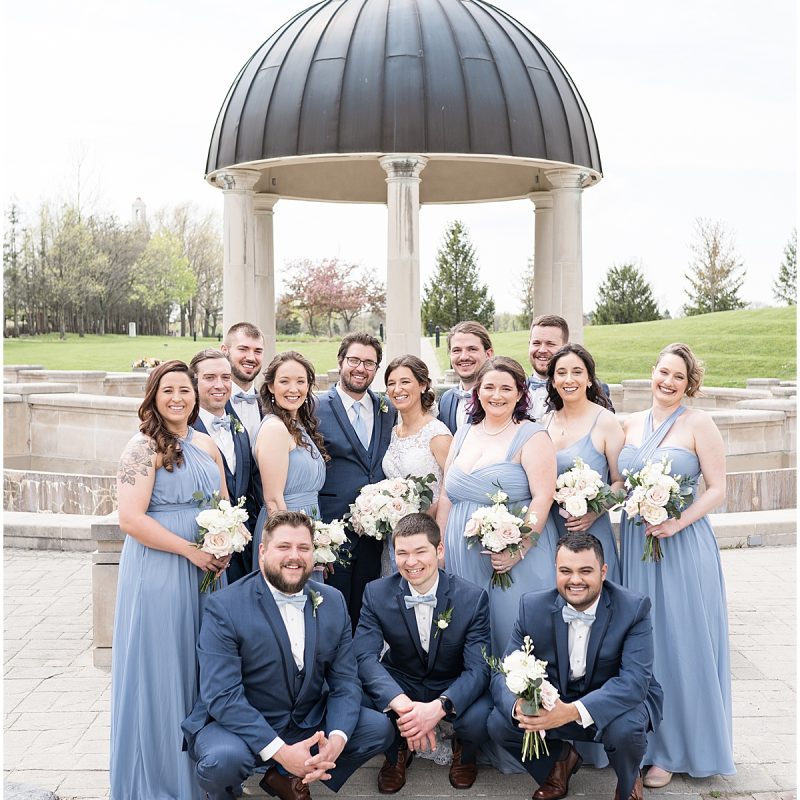Bridal party pose together during wedding photos at Coxhall Gardens