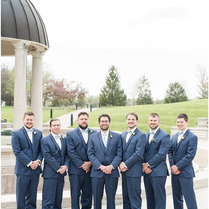 Groom and groomsmen during wedding photos at Coxhall Gardens
