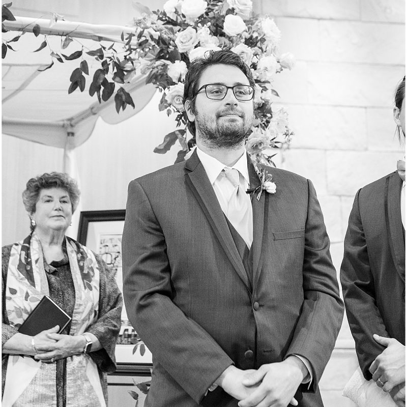 Groom standing at alter during wedding at at Indianapolis Hebrew Congregation