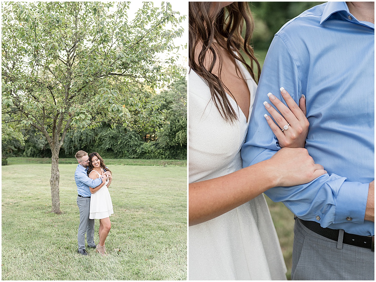 Couple standing under tree during summer engagement photos at Holcomb Gardens in Indianapolis