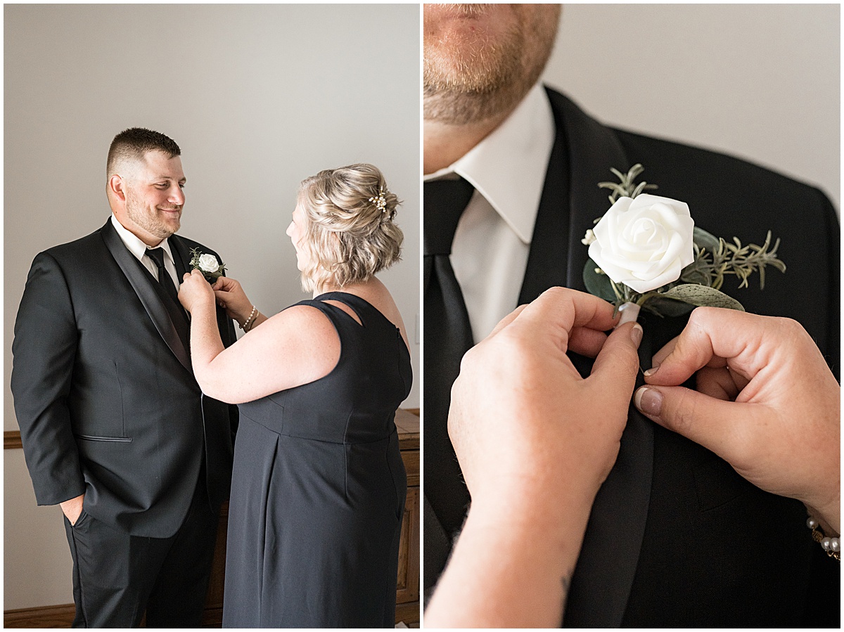 Broom getting boutonnière on before wedding in Converse, Indiana