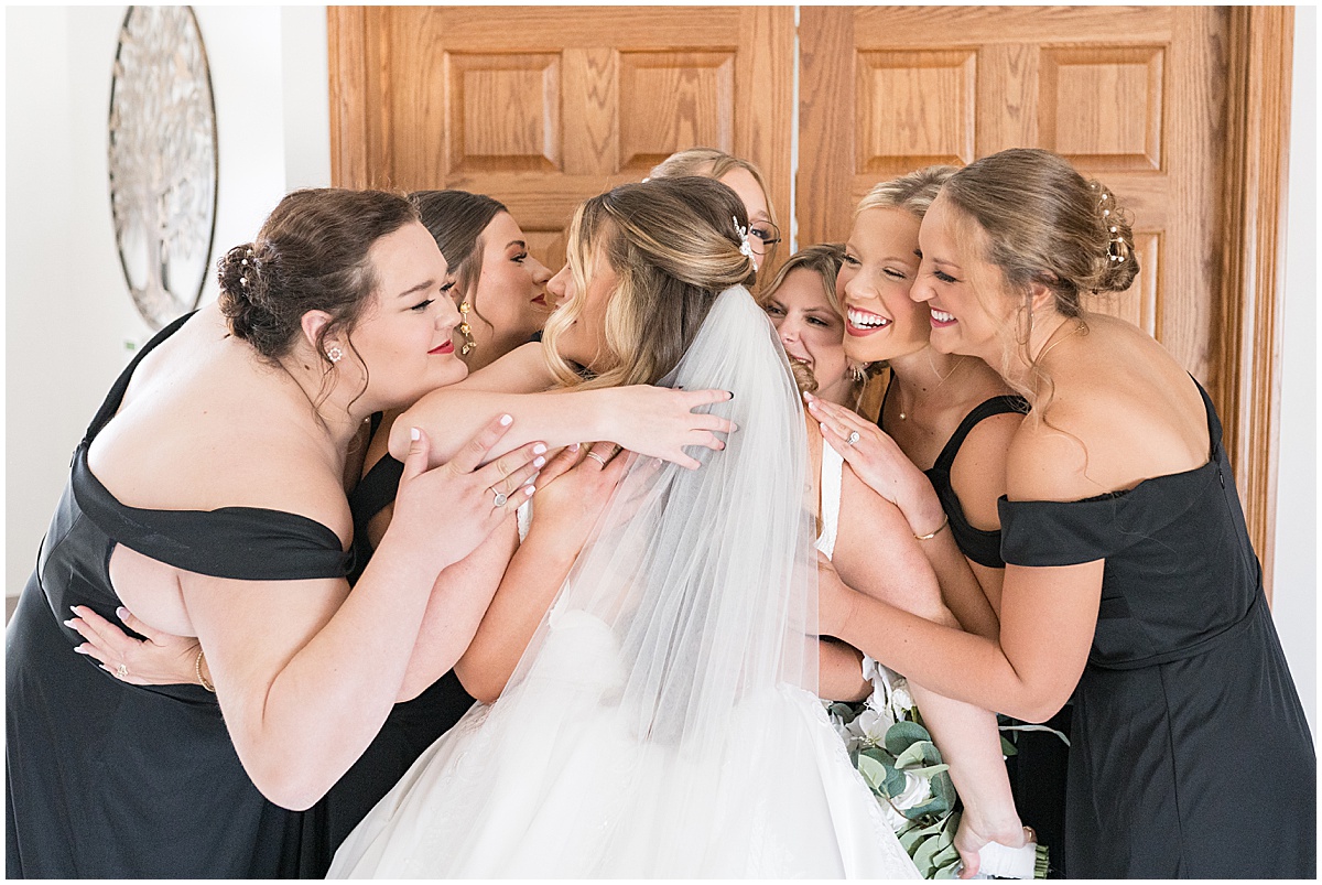 Bridesmaids hug bride before wedding in Converse, Indiana