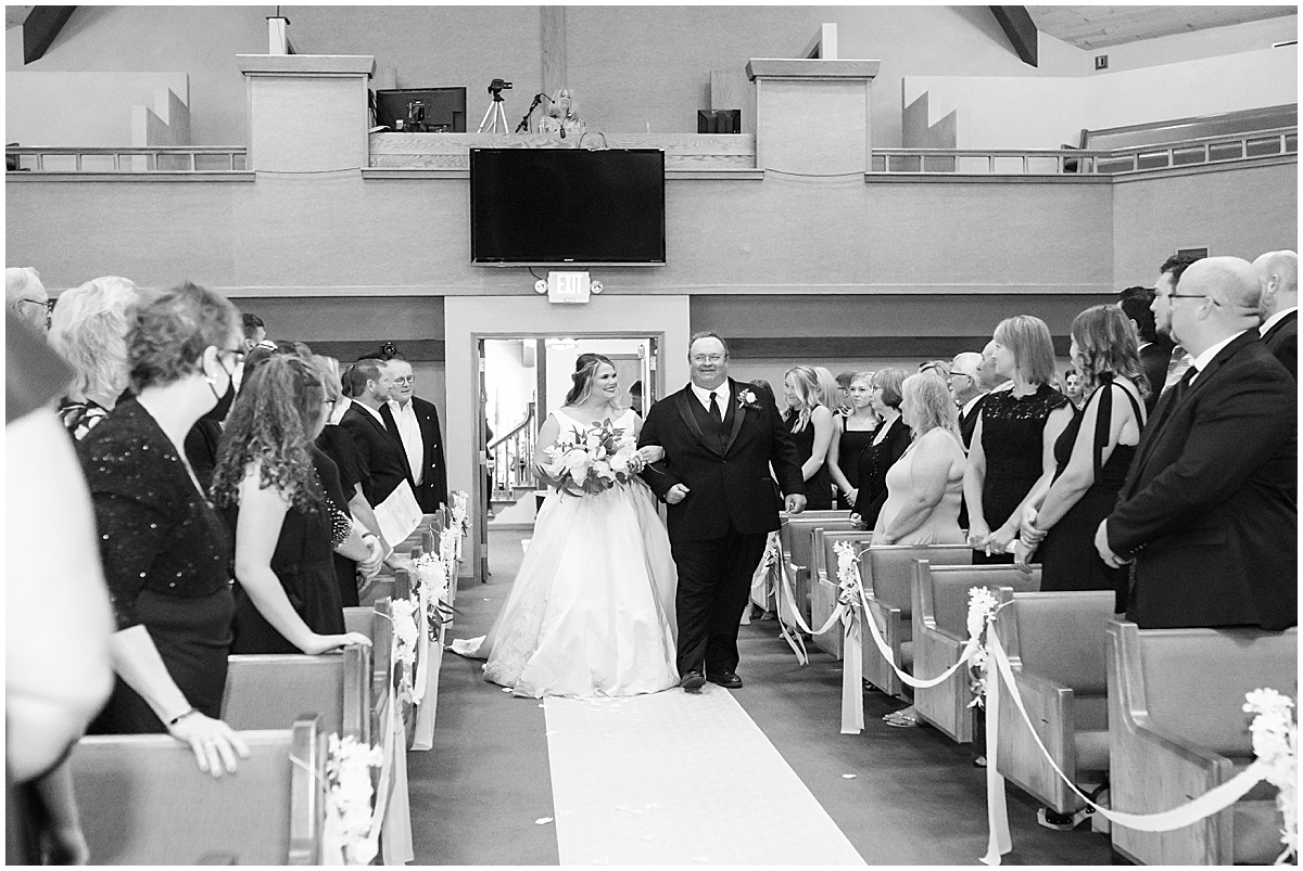 Bride walking down the aisle at wedding in at Converse Church of Christ in Converse, Indiana