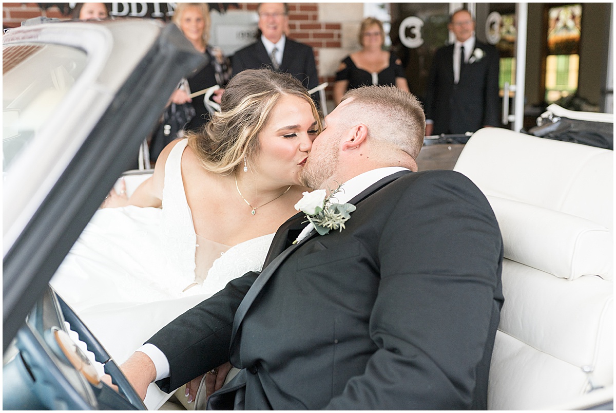 Newlyweds kiss at exit of wedding in at Converse Church of Christ in Converse, Indiana