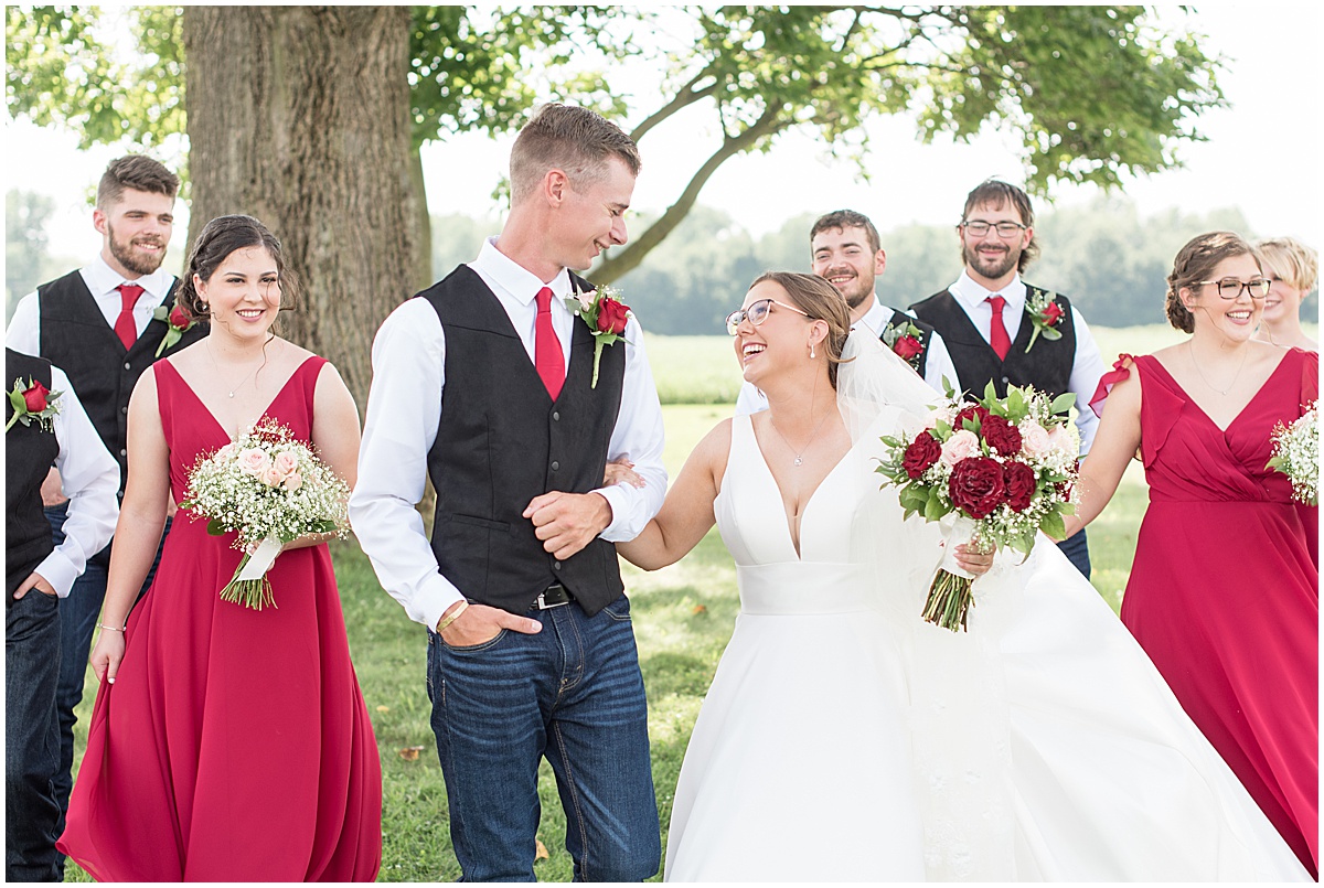 Bride and groom laugh with wedding party at Churchill Farms wedding in Lake Village, Indiana