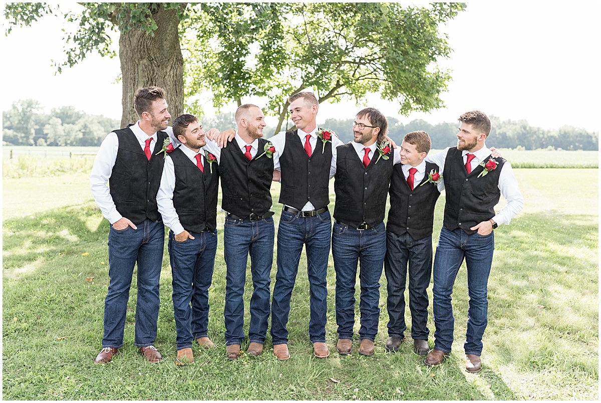 Groomsmen hugging at Churchill Farms wedding in Lake Village, Indiana