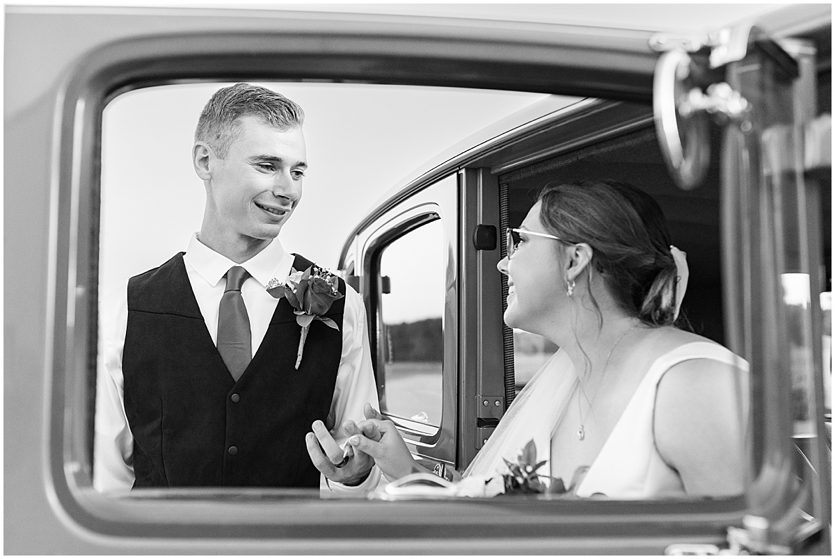 Bride and groom with vintage car at Churchill Farms wedding in Lake Village, Indiana