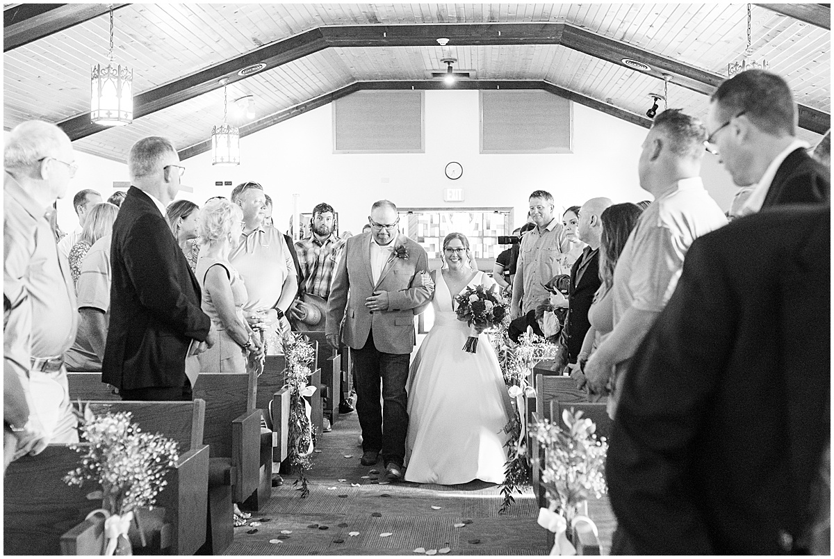 Bride walking down the aisle at wedding ceremony at St. Augusta Catholic Church in Lake Village, Indiana