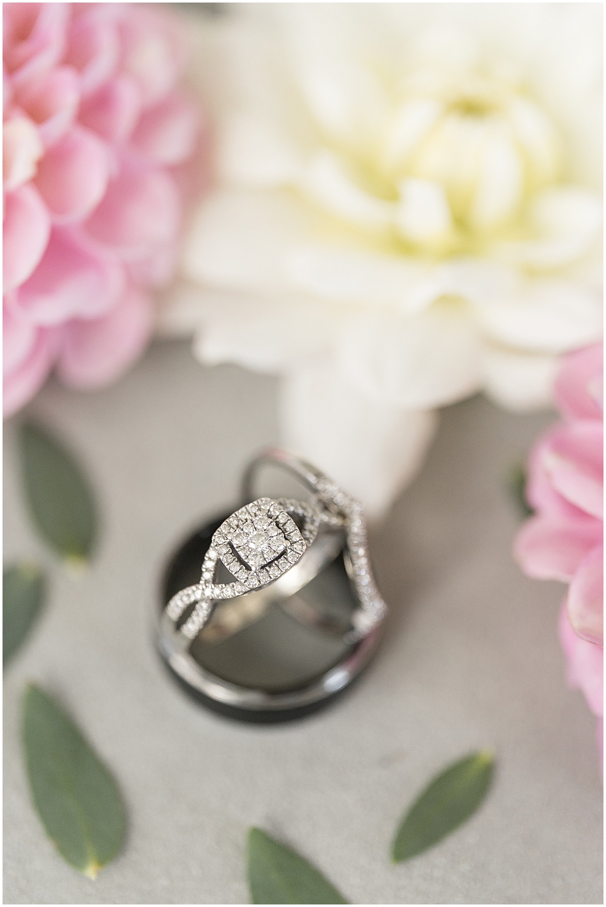 Close up of wedding rings for pastel wedding at New Journey Farms in Lafayette, Indiana