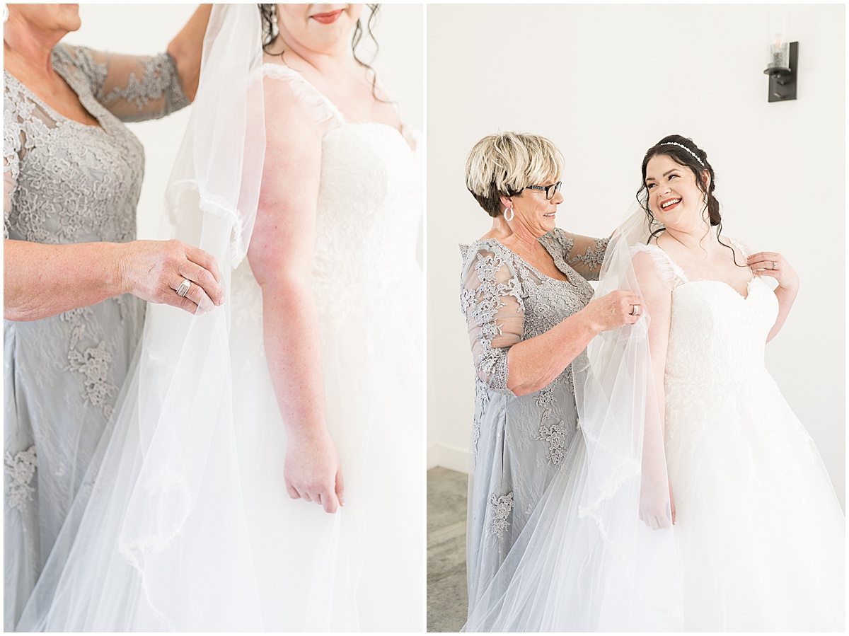 Mother helping bride button up dress for pastel wedding at New Journey Farms in Lafayette, Indiana