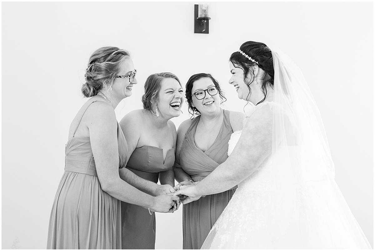 Bridesmaids reaction to bride before pastel wedding at New Journey Farms in Lafayette, Indiana
