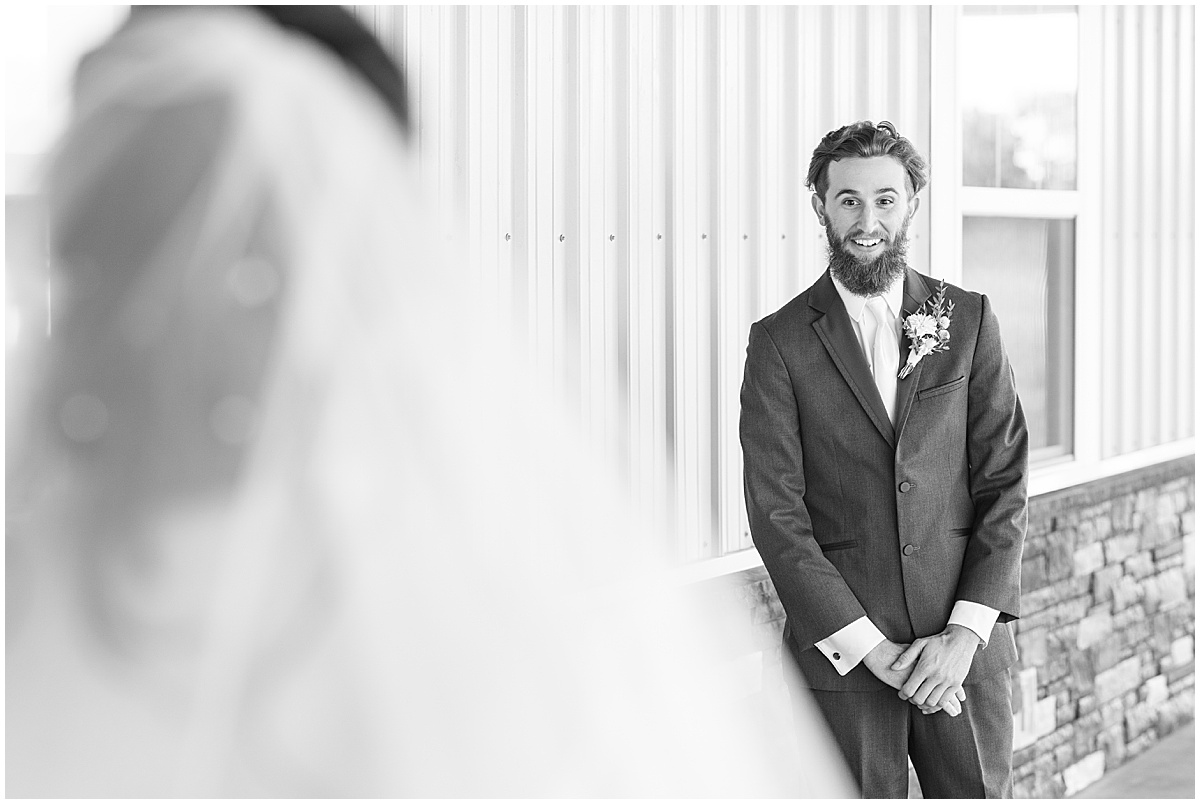 Groom reaction to bride during first look before pastel wedding at New Journey Farms in Lafayette, Indiana