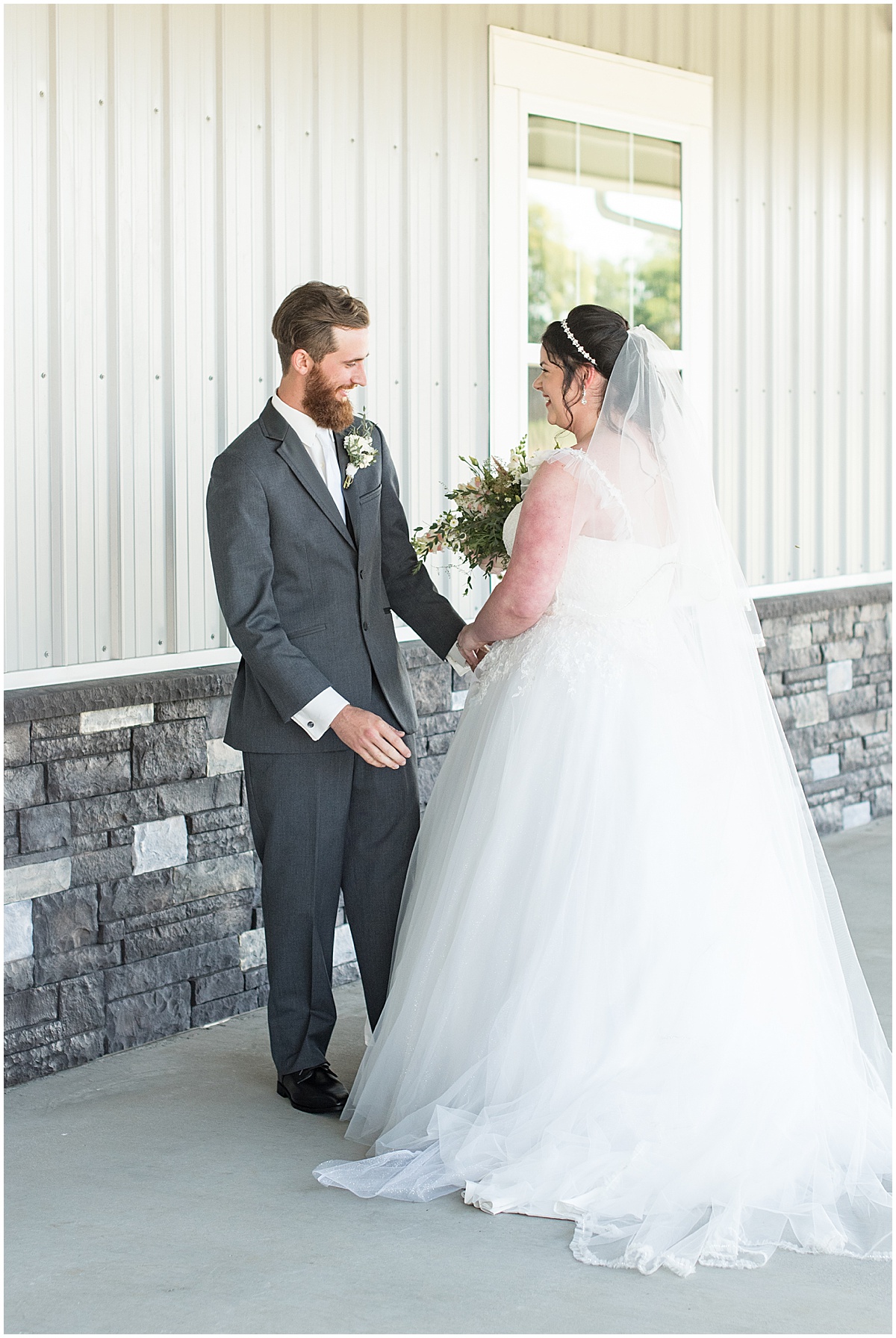 Groom reaction to bride during first look before pastel wedding at New Journey Farms in Lafayette, Indiana