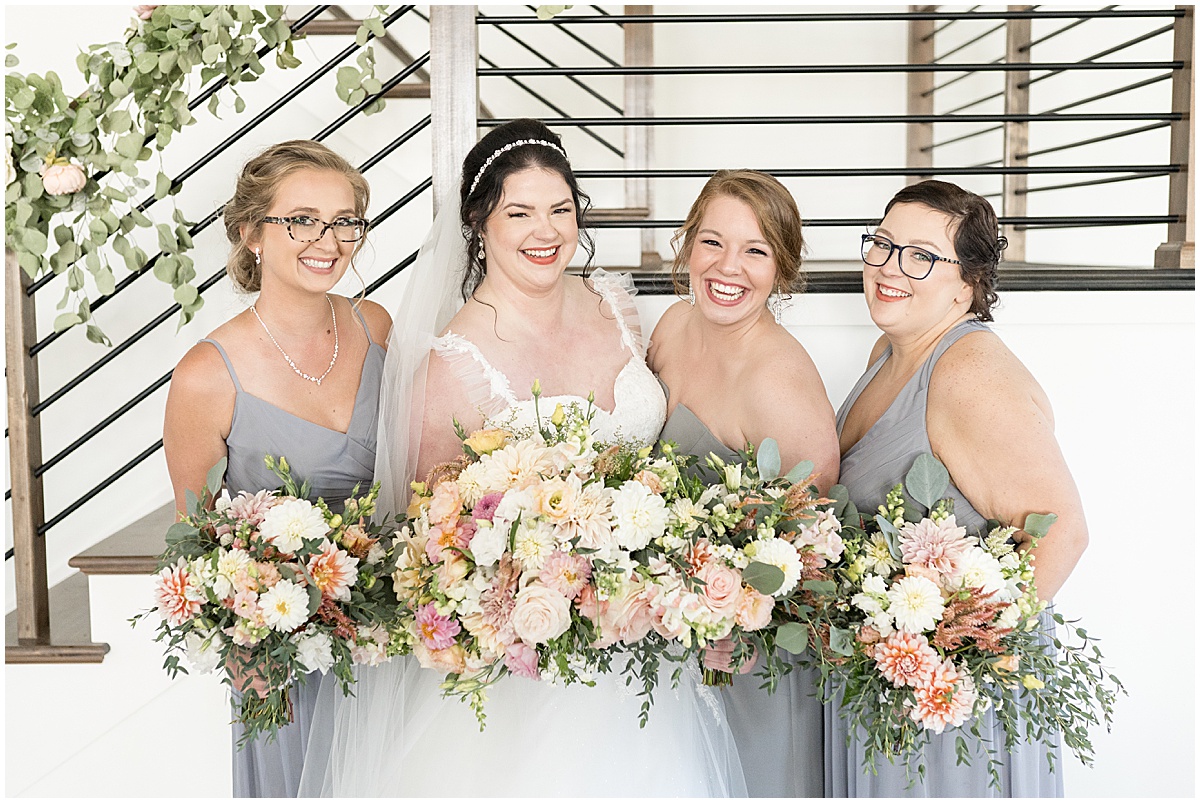 Bride with bridesmaids at pastel wedding at New Journey Farms in Lafayette, Indiana