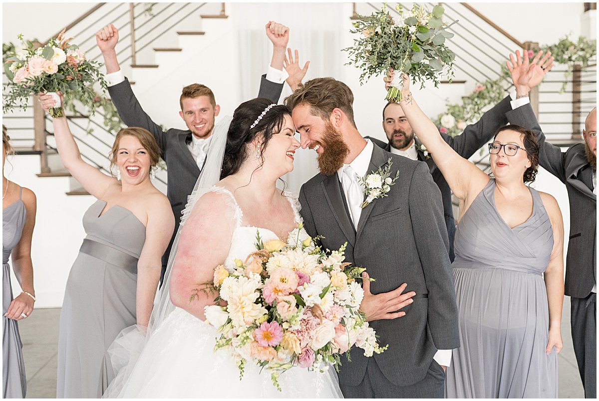 Bridal party celebrates bride and groom at pastel wedding at New Journey Farms in Lafayette, Indiana