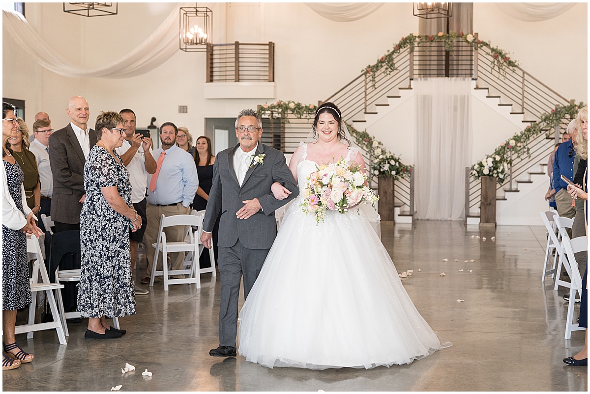 Bride walking down the aisle at pastel wedding at New Journey Farms in Lafayette, Indiana