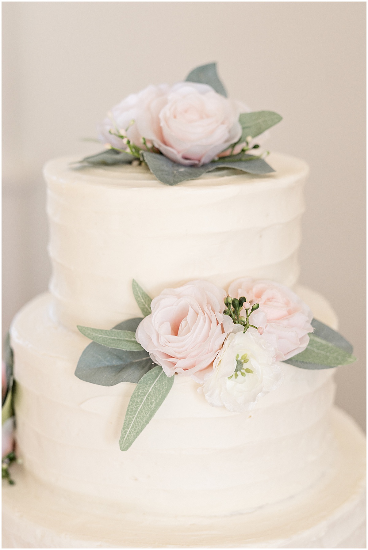 Wedding cake with pink flowers for pastel wedding at New Journey Farms in Lafayette, Indiana