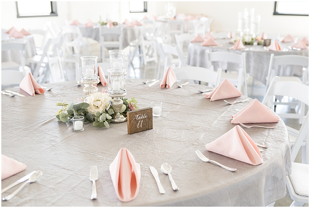 Gray table with pink napkins for pastel wedding at New Journey Farms in Lafayette, Indiana