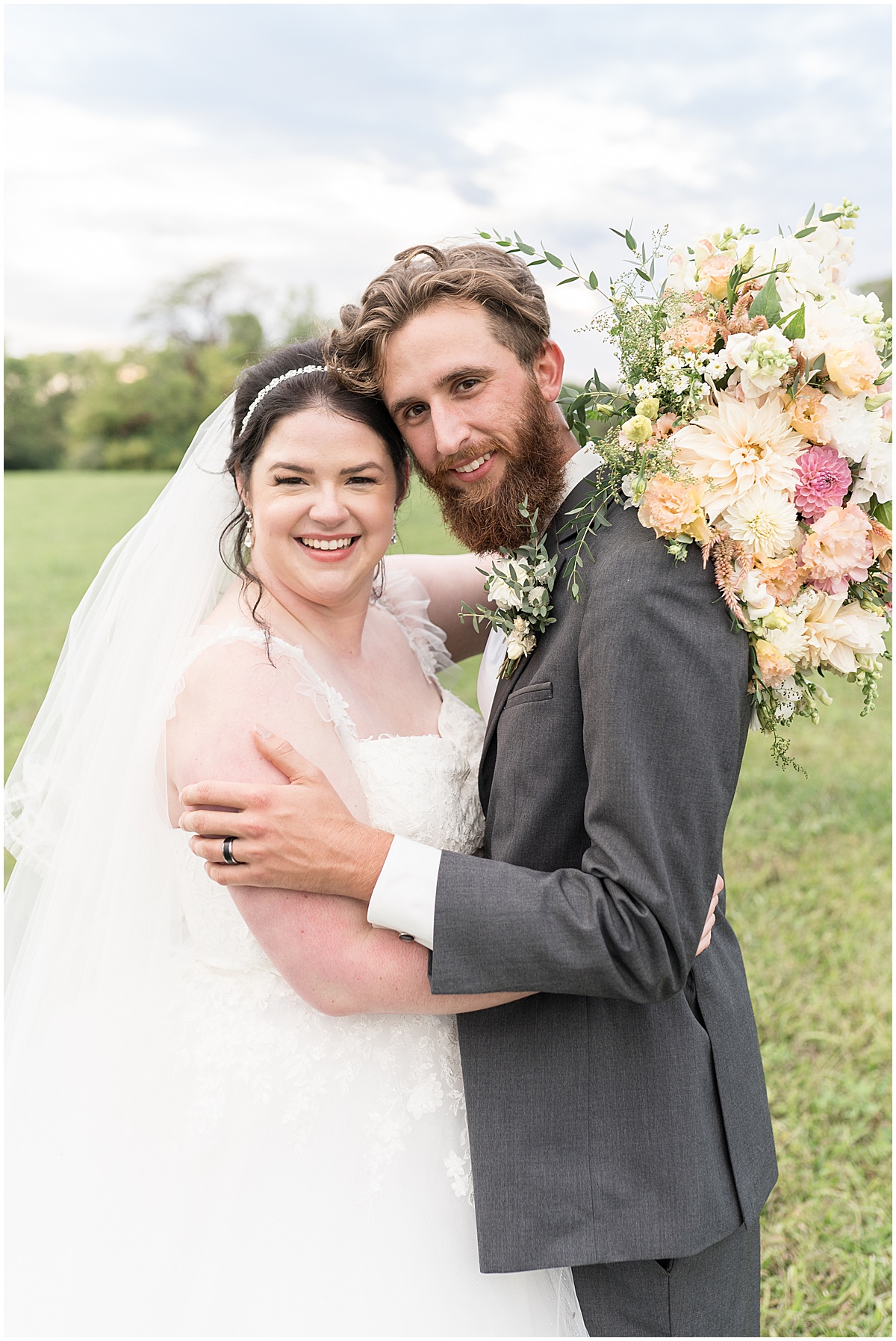 Bride and groom hug after pastel wedding at New Journey Farms in Lafayette, Indiana