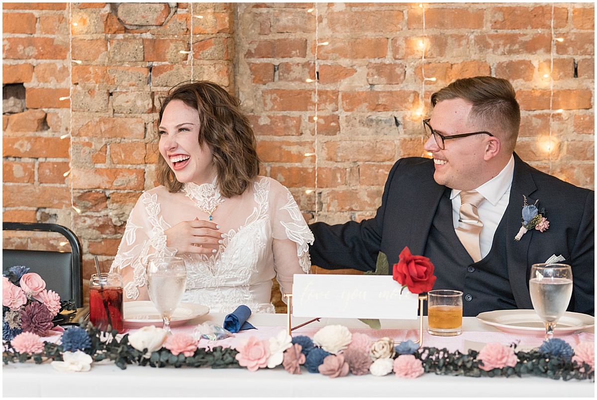 Newlyweds laughing at fall wedding at The Rat Pak Venue in Downtown Lafayette, Indiana